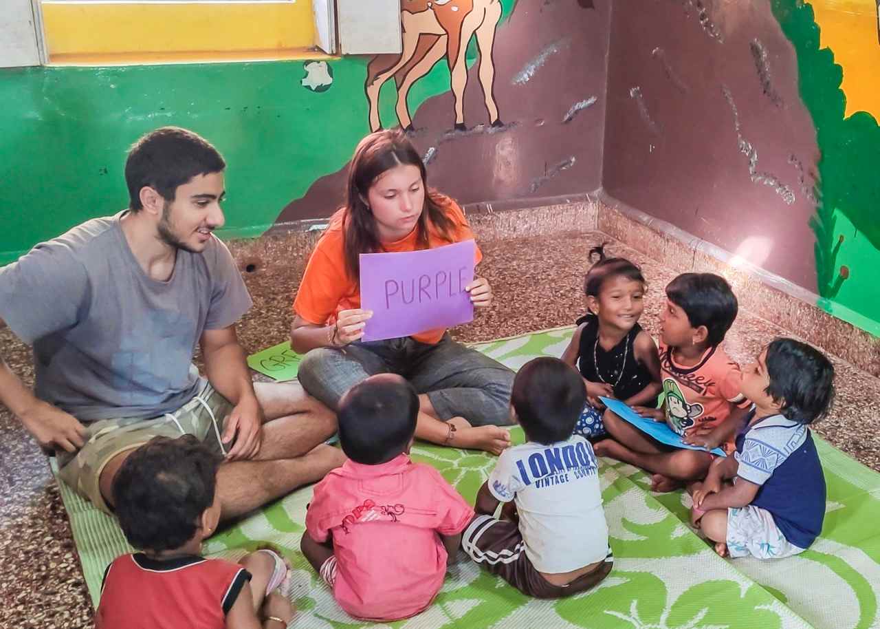 Two volunteers during an educational activity with children